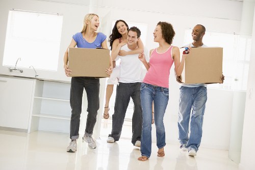 Furniture collection team handling bulky items in a Merton home