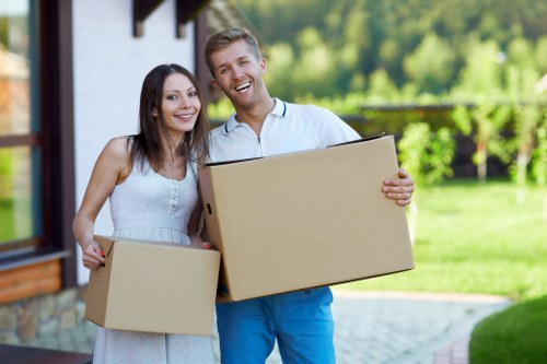 Professional packers preparing household items for a move in Merton