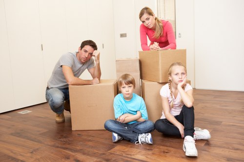 Movers loading household items for a relocation in Merton