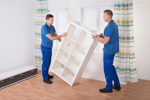 Local moving team loading furniture into a van in Merton